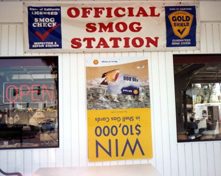 Gas station wall with a poster upside-down.