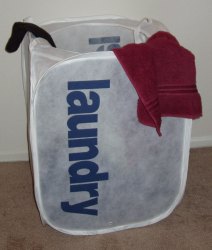 Collapsible laundry basket, clearly labeled.