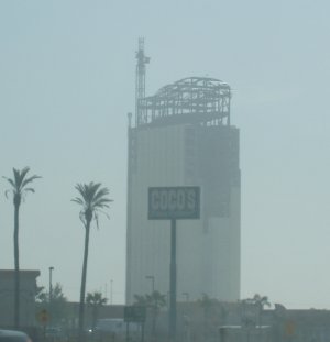 A high-rise under construction, the top scaffolding looking suspiciously like a roller coaster.