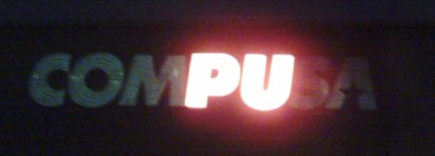 CompUSA sign with only PU lit