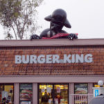 Half-inflated Darth Vader atop a Burger King restaurant.