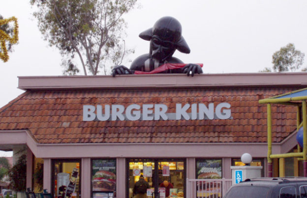 Half-inflated Darth Vader atop a Burger King restaurant.