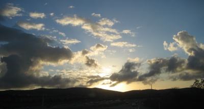 Light and shadow among patchy clouds near sunset on Monday, February 12