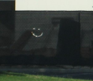 Fence with happy face cut into it