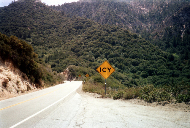 Warning sign by road: Icy.  Everything’s green.