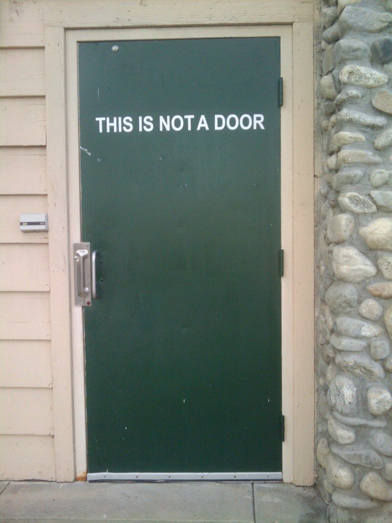 Photo of a door with a sign that says This Is Not a Door.