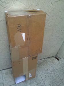 Two carboard boxes taped together to make them longer.