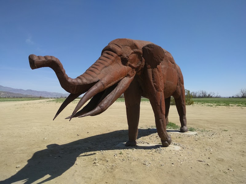 Metal statue of an elephant, or possibly a mastodon or mammoth.
