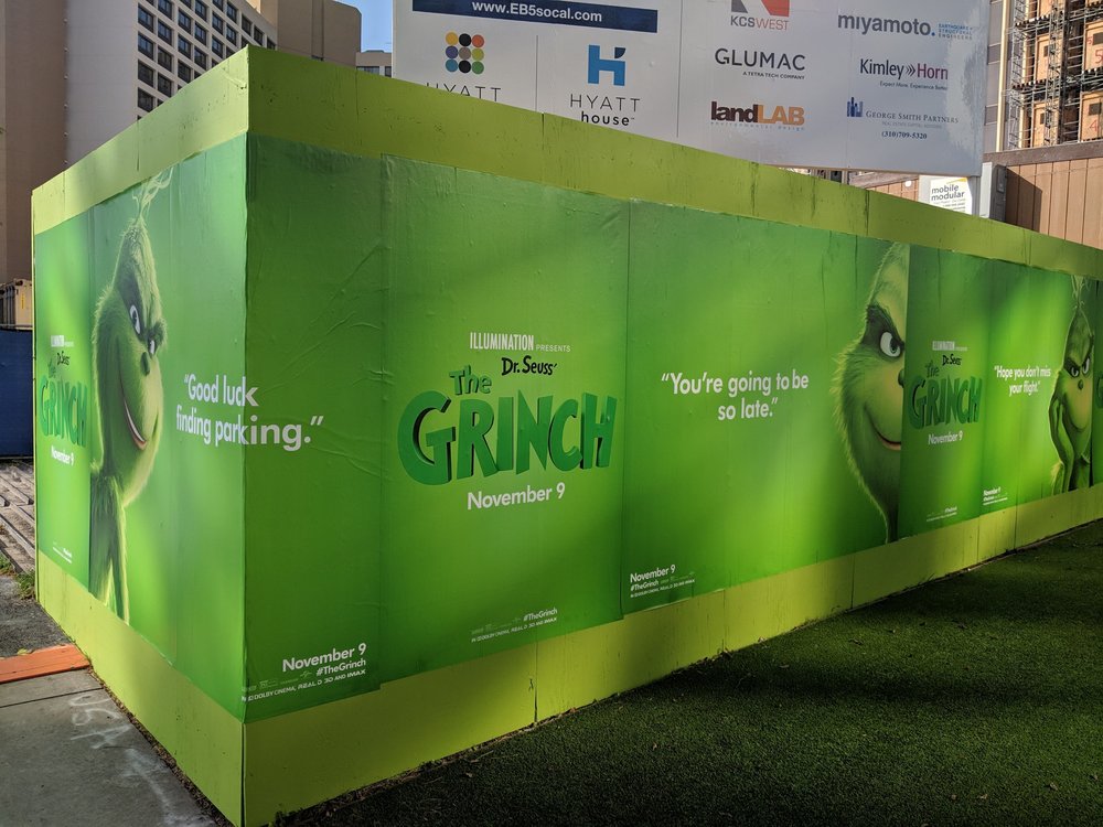 Grinch posters with captions including " You're going to be so late!" and "Good luck finding parking!"