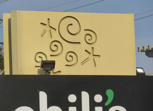 Swirls and stars on a sign. OK, they're starfish and waves, but still...