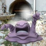 A Muk in a drainage ditch near a grate.