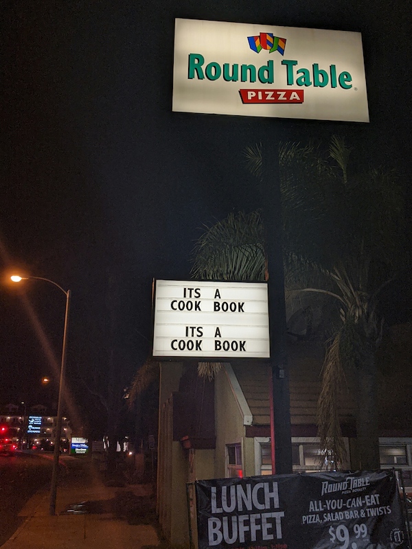 Round Table Pizza sign saying It's a cook book! It's a cook book!