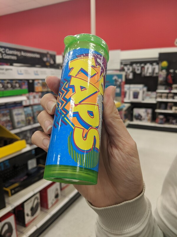 A tube found in a store labeled KAPS, with patterns and angles and bright colors.
