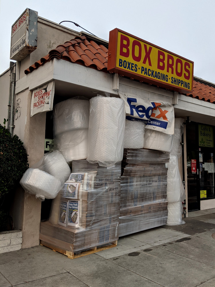 Box Bros. storefront completely blocked by packing material.